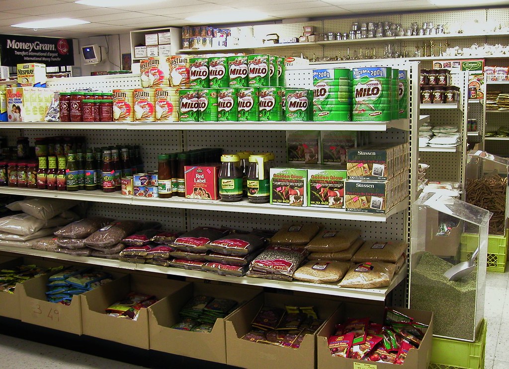 Shelves stocked with packaged grocery and household consumer goods